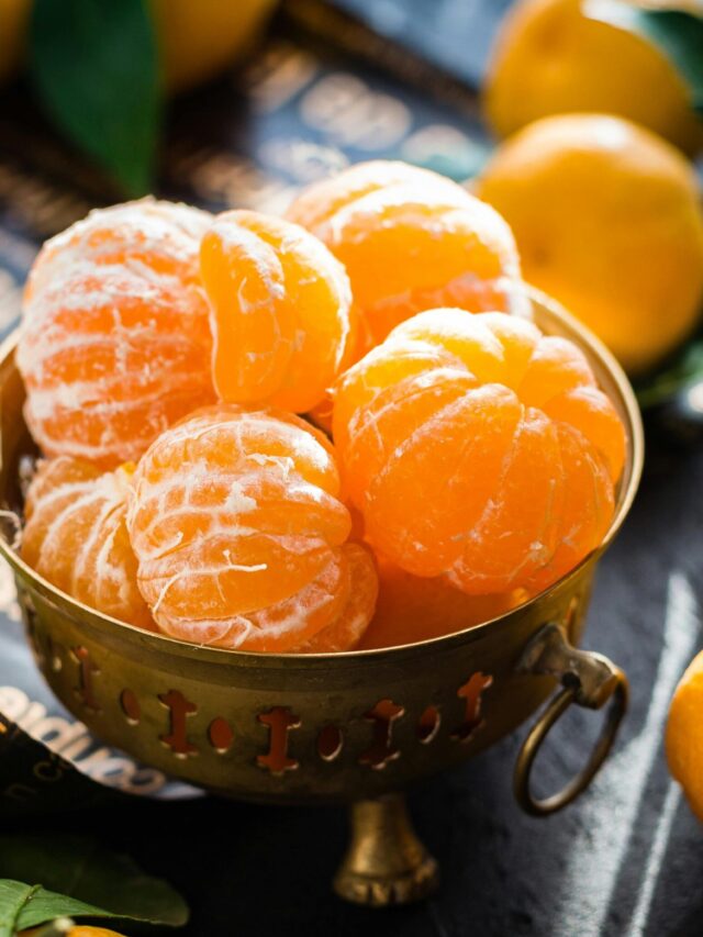 Vibrant peeled and whole tangerines in a rustic bowl highlighting freshness and health.